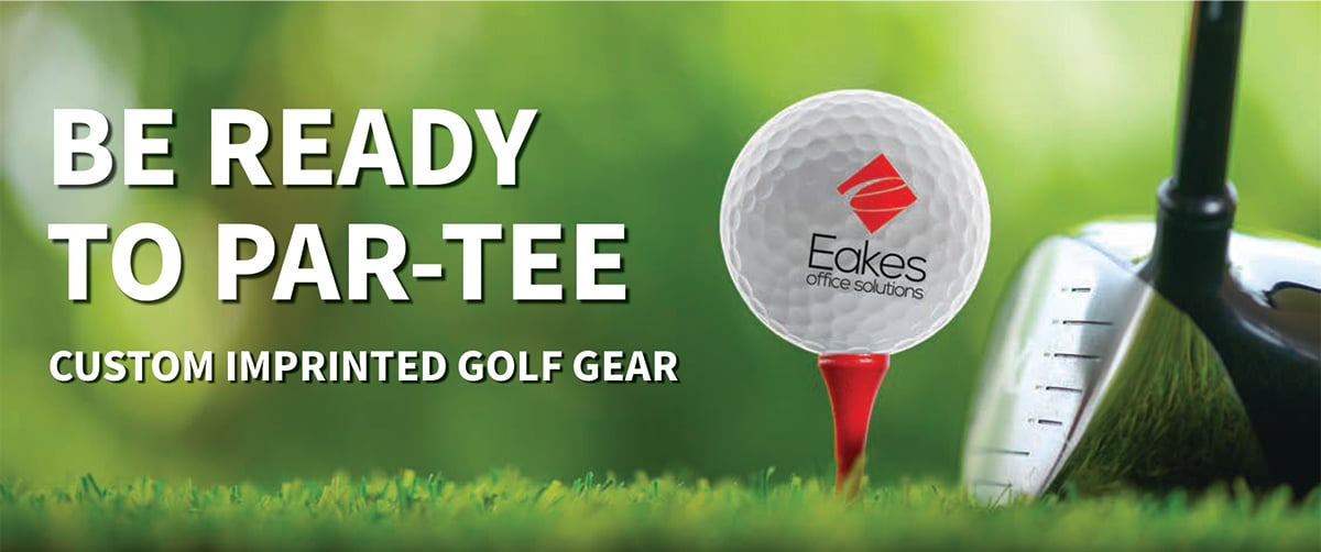 A golf ball with Eakes logo it placed on a red tee.